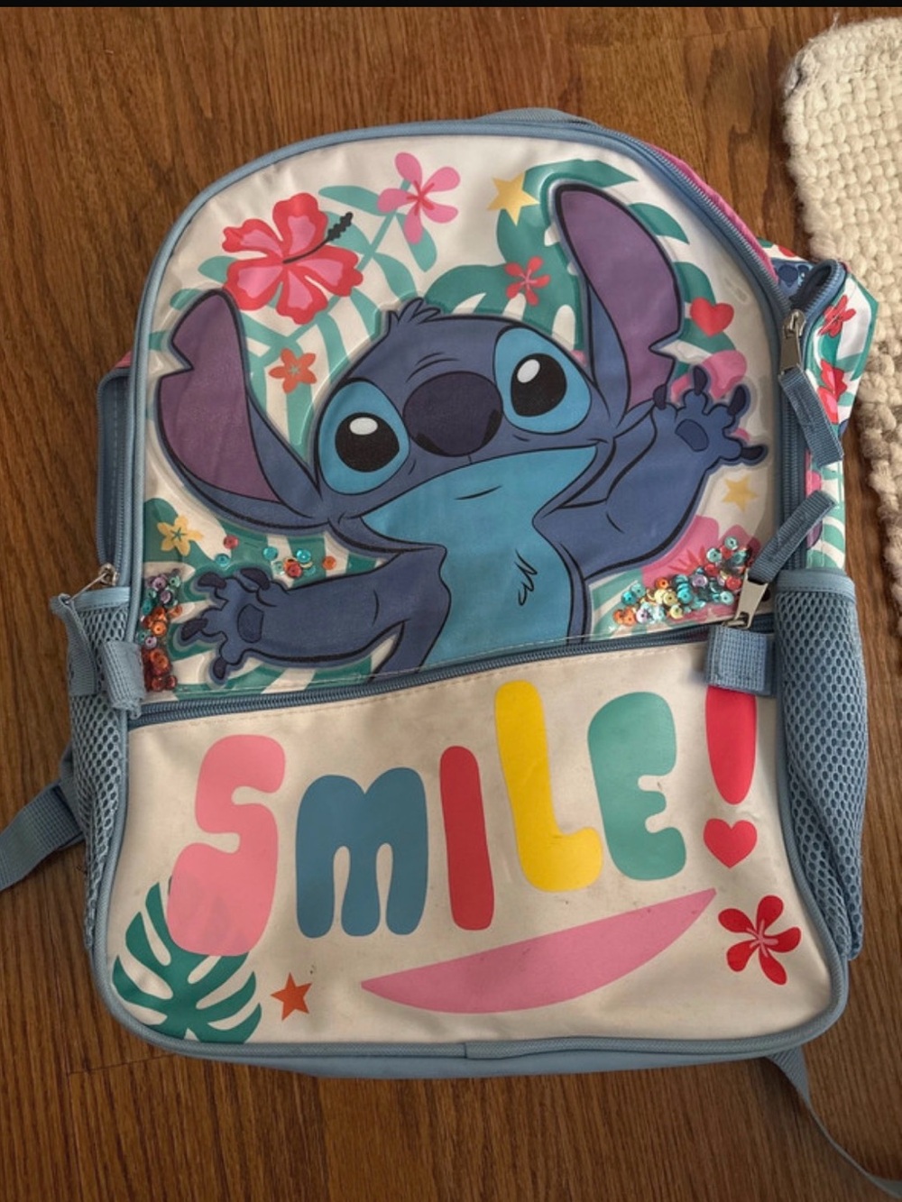 Disney Stitch Light Blue Backpack with Colorful 'Smile' Print
